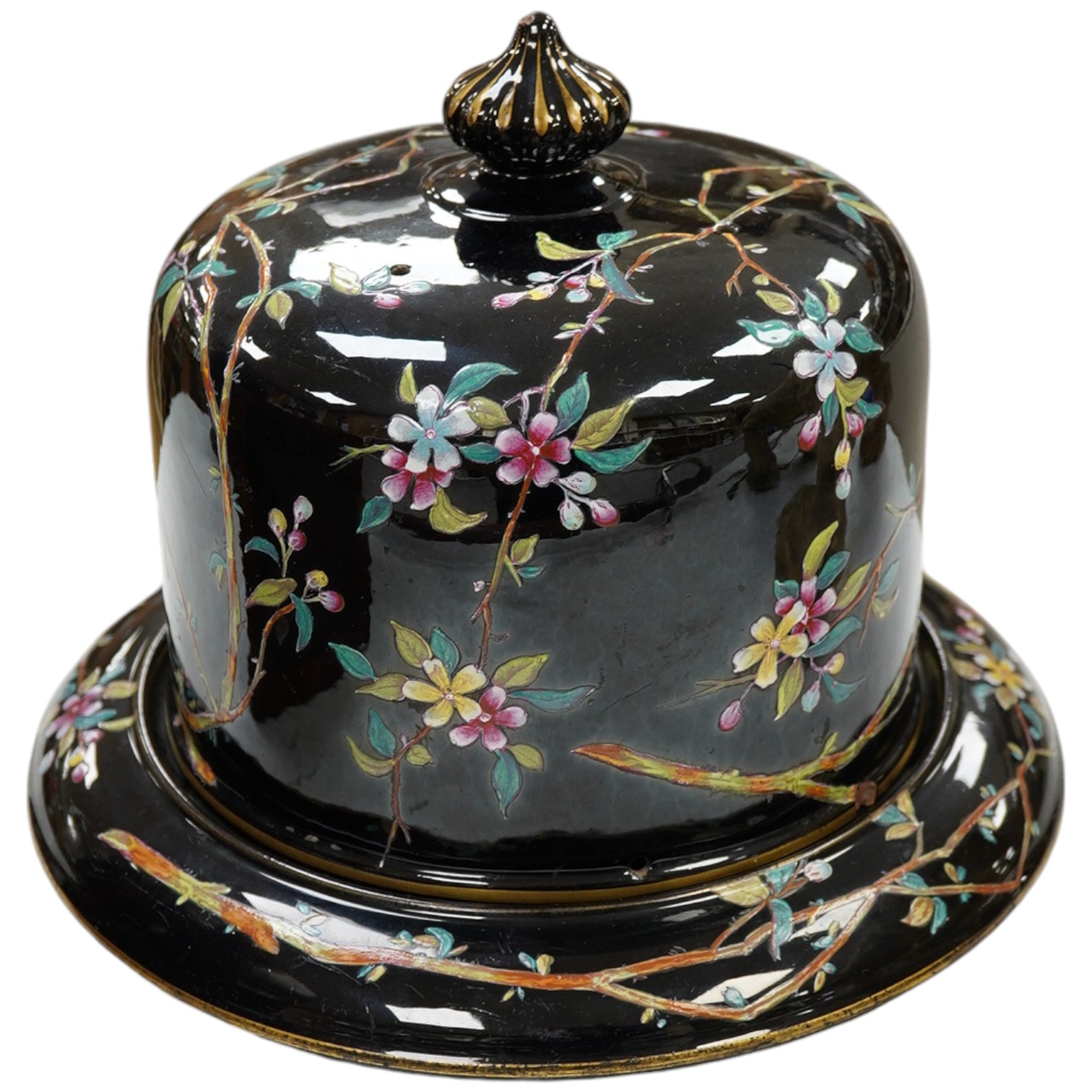 A Victorian cheese dome and stand, black ground with floral decoration, 22cm high. Condition - fair to good